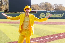 Jesse Cole of the Savannah Bananas in a yellow suit and hat on a baseball field